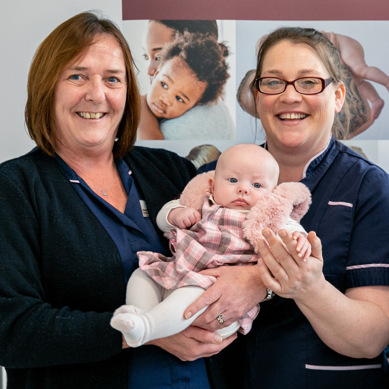 Fertility Nurse Specialists Jackie Richardson and Angela Leach with an Essex Bourn Hall baby